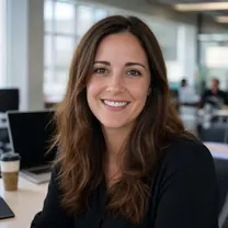 A marketing agency account manager at her desk, smiling.